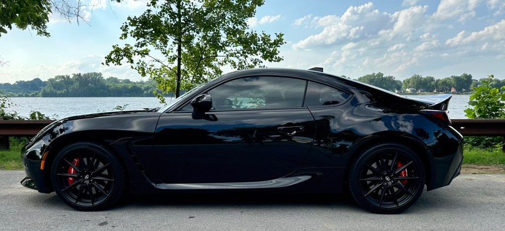 The image shows a sleek black low-to-the-ground Toyota sports car.
